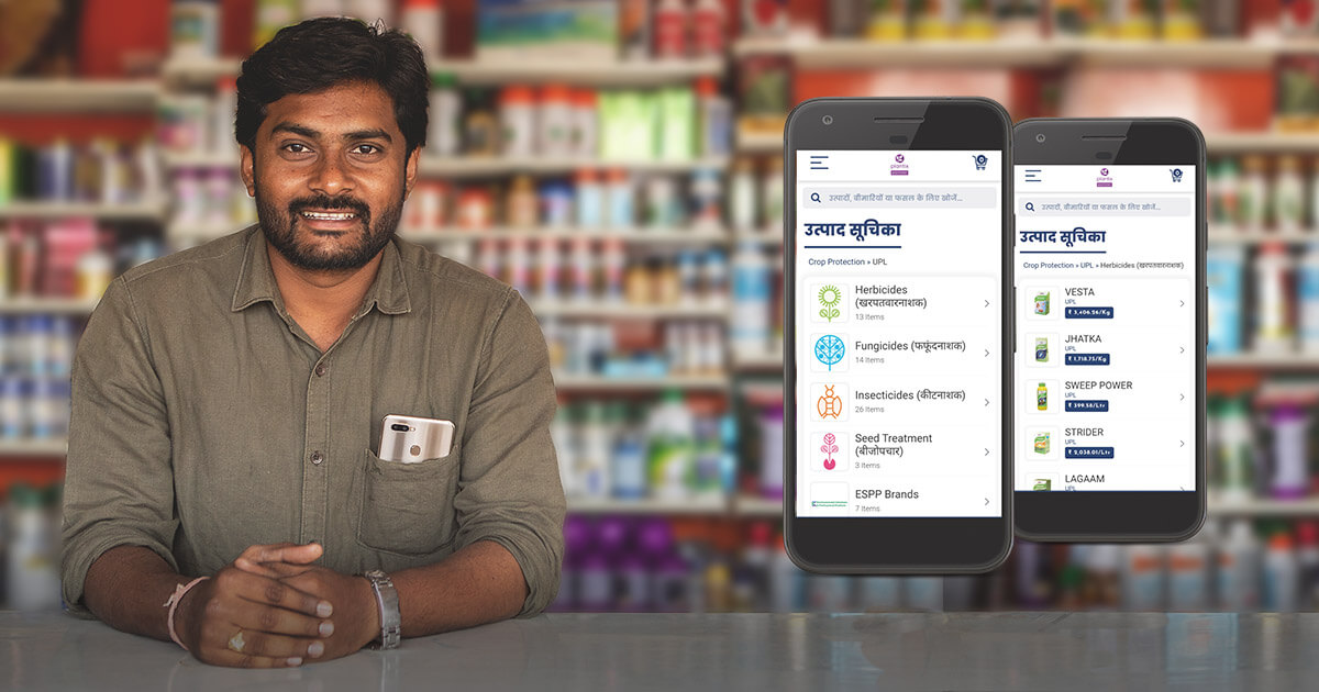An Agri-Input dealer holds his mobile and leans smilingly over his counter. He holds a phone in his hand. To his right, there are two app screens. Below him, there is the Plantix Partner logo and a slogan stating: The one stop solution for agri-retailers in India.